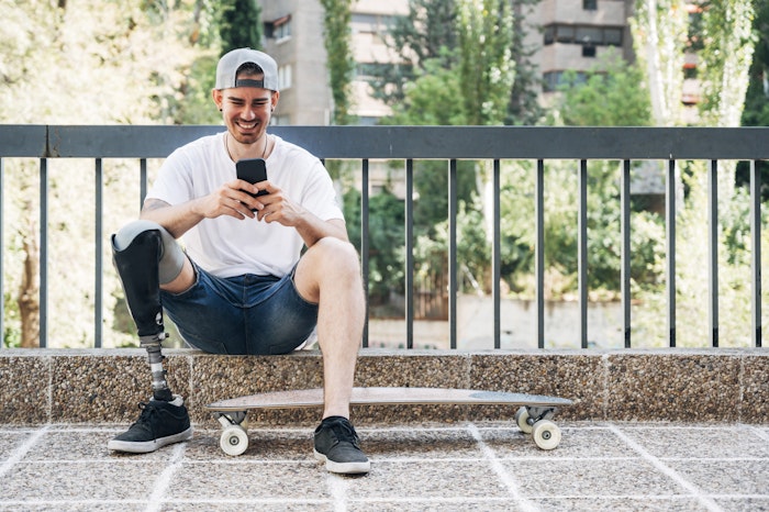 young-man-with-skateboard-on-phone-jpg