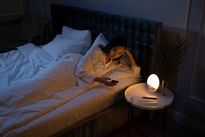 woman-in-bed-on-phone-jpg