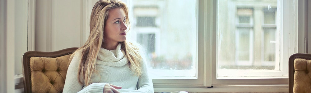 woman-sitting-next-to-window-jpg