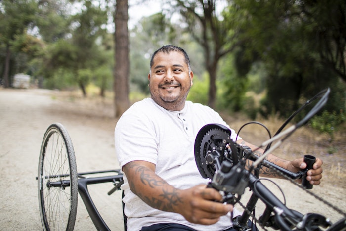 a-man-riding-a-hand-cycle-bike-jpg-jpg