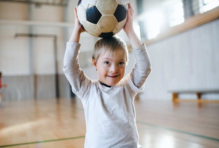 young-boy-holding-soccer-ball-jpg